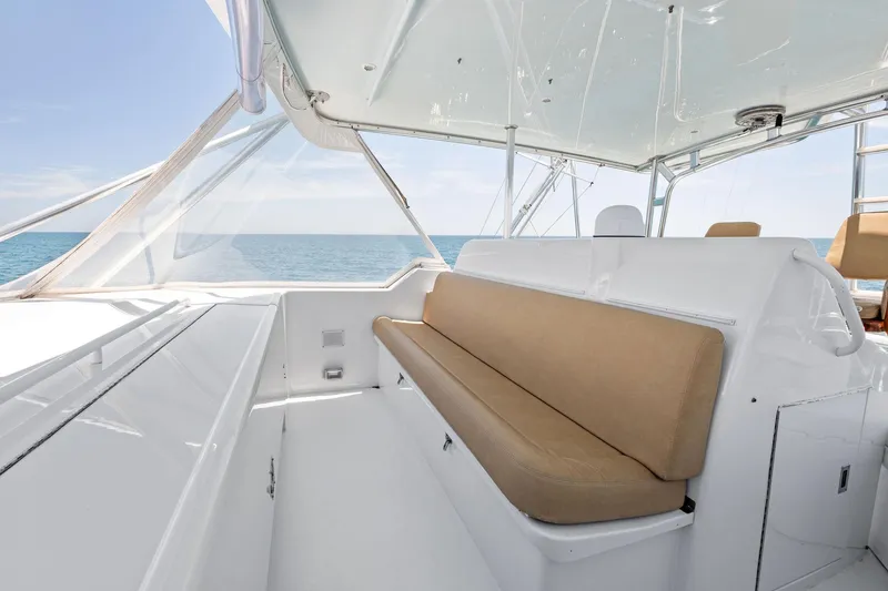 Slide: The Image of 1998 Hatteras 60 Convertible yacht interior with beige seating and ocean view. - 18