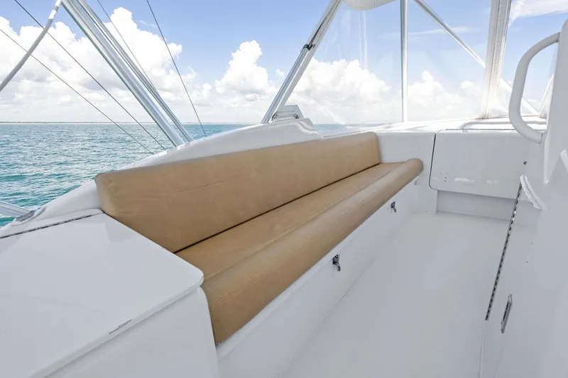 Slide: The Image of 1998 Hatteras 60 Convertible yacht interior with beige seating and ocean view. - 19