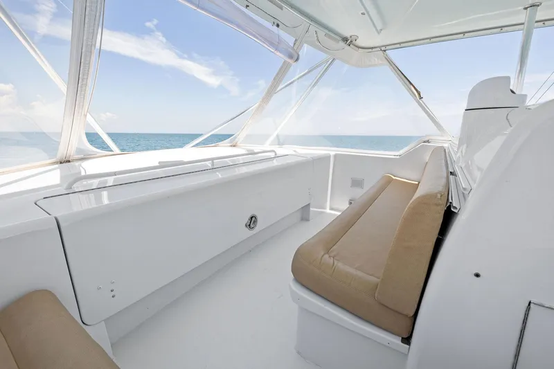 Slide: The Image of 1998 Hatteras 60 Convertible yacht interior with beige seating and ocean view. - 20