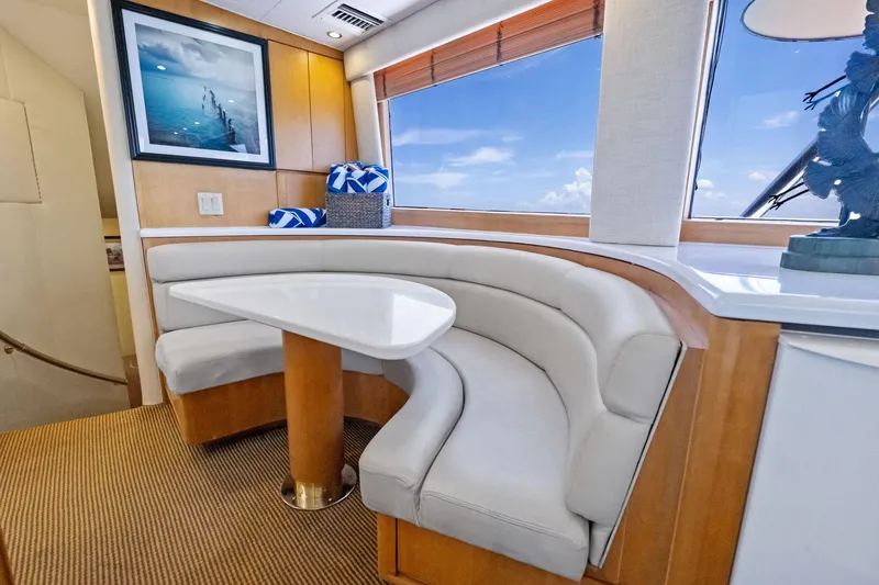 Slide: The Image of Interior of 1998 Hatteras 60 Convertible yacht with curved seating and table. - 35