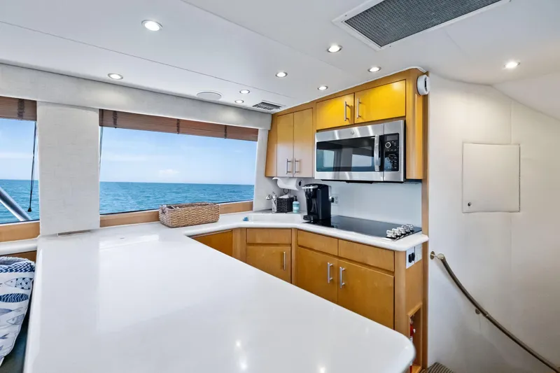 Slide: The Image of Luxurious kitchen interior of 1998 Hatteras 60 Convertible yacht with ocean view. - 38