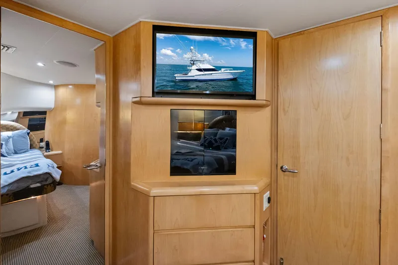 Slide: The Image of Interior of 1998 Hatteras 60 Convertible yacht with wood paneling and TV. - 42