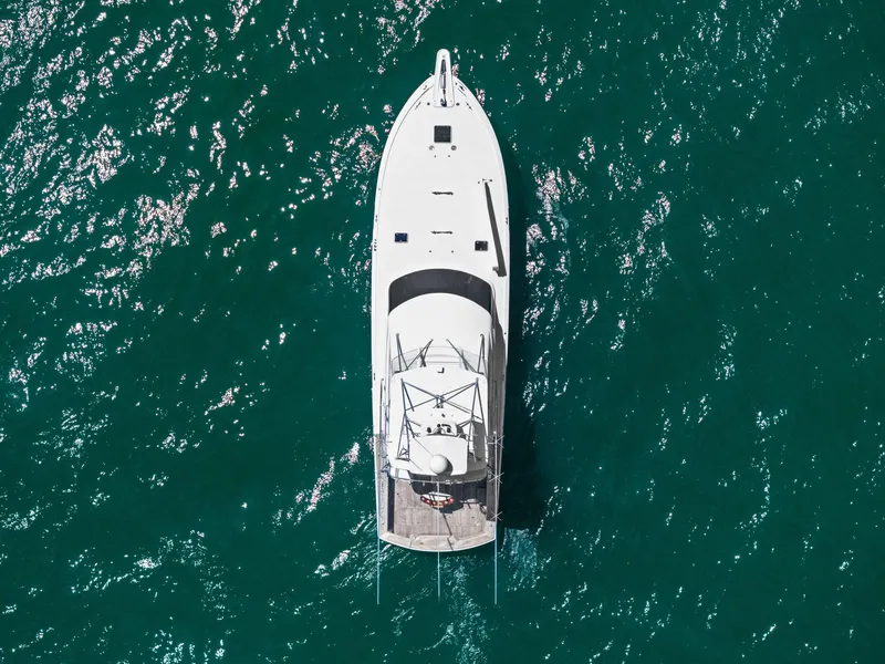 Slide: The Image of Aerial view of 1998 Hatteras 60 Convertible yacht on sparkling blue water. - 7
