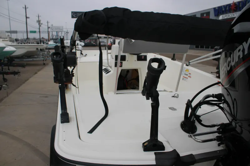 Slide: The Image of 2021 Mako Pro Skiff 17 CC boat with Mercury engine, docked at a marina. - 11