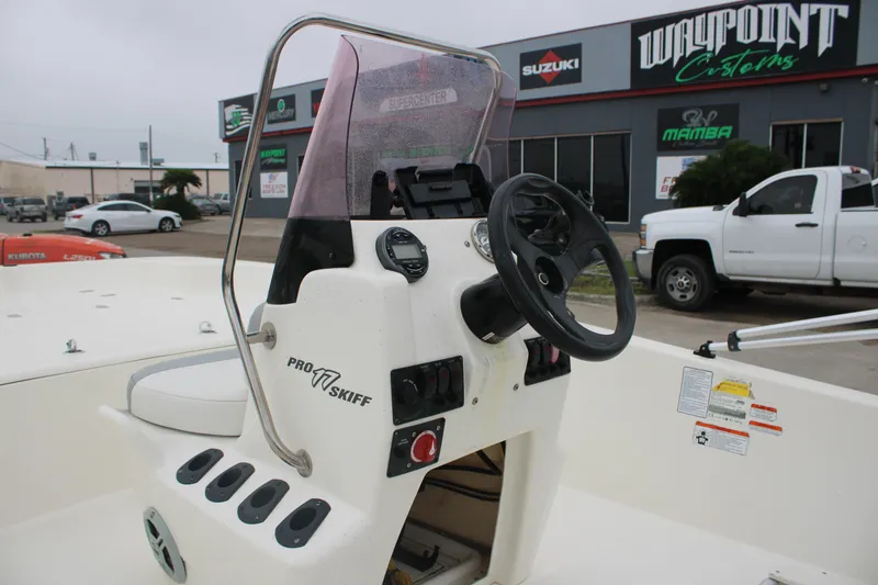 Slide: The Image of 2021 Mako Pro Skiff 17 CC boat console with steering wheel and controls. - 2