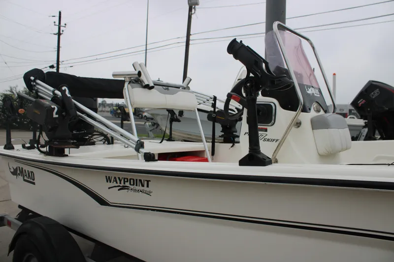 Slide: The Image of 2021 Mako Pro Skiff 17 CC boat with fishing equipment and console details. - 3
