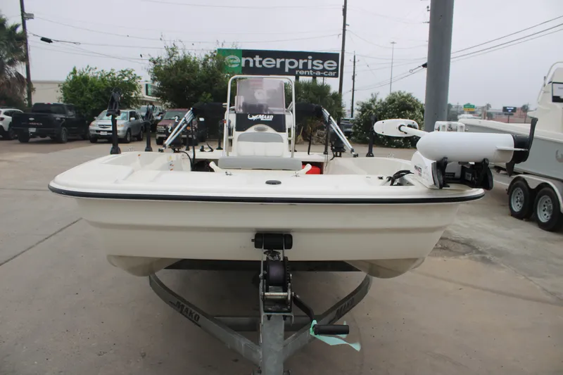 Slide: The Image of 2021 Mako Pro Skiff 17 CC boat on trailer in parking lot. - 4