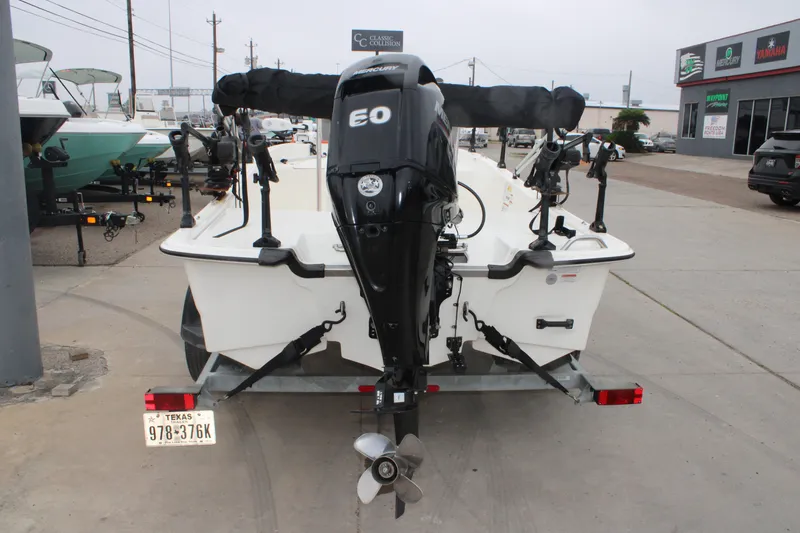 Slide: The Image of 2021 Mako Pro Skiff 17 CC boat on trailer, rear view with outboard motor. - 5