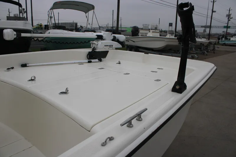 Slide: The Image of 2021 Mako Pro Skiff 17 CC boat with Minn Kota trolling motor, docked outdoors. - 7