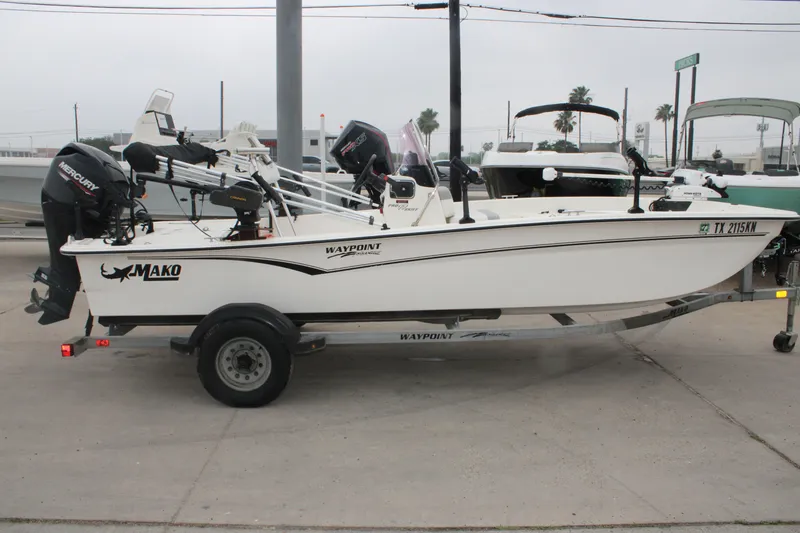 Slide: The Image of 2021 Mako Pro Skiff 17 CC boat on trailer, equipped with Mercury outboard motor. - 8