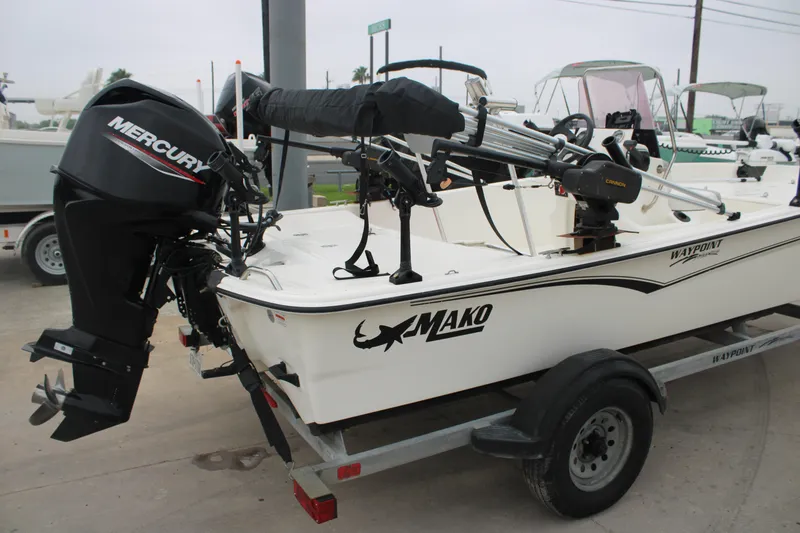 Slide: The Image of 2021 Mako Pro Skiff 17 CC boat with Mercury outboard motor on trailer. - 9