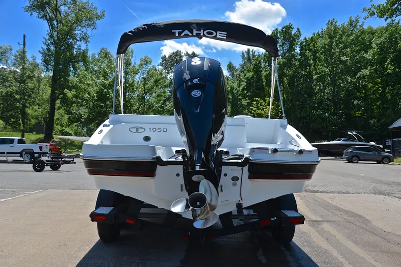 Slide: The Image of Rear view of a 2018 Tahoe 1950 boat on a trailer, parked outdoors. - 13