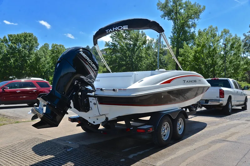 Slide: The Image of Tahoe 1950 boat from 2018 on trailer, featuring Mercury outboard motor. - 14