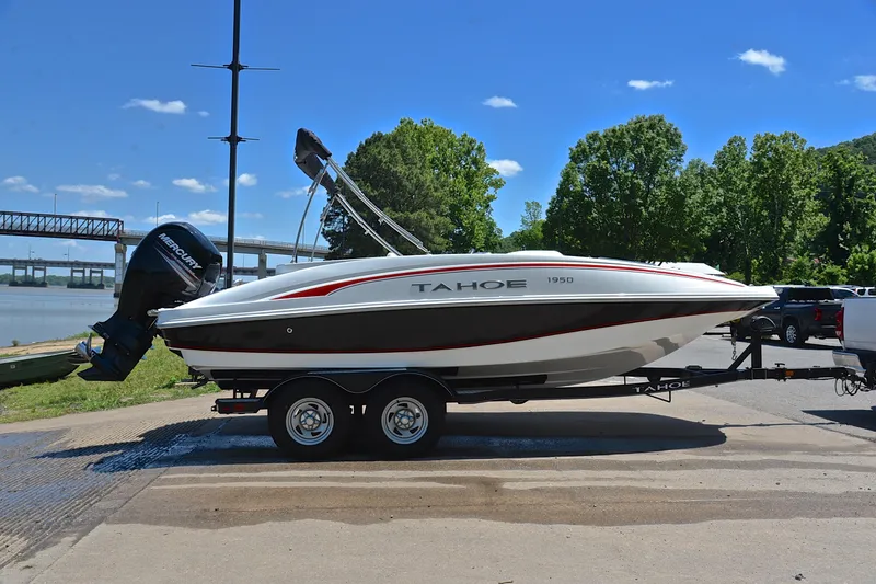 Slide: The Image of Tahoe 1950 boat on trailer by river, sunny day, 2018 model. - 15