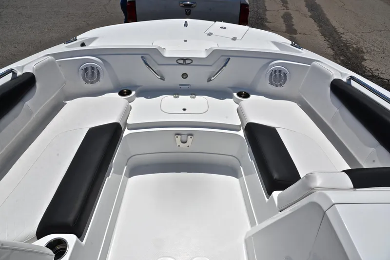 Slide: The Image of Interior of a 2018 Tahoe 1950 boat with white seating and cup holders. - 21