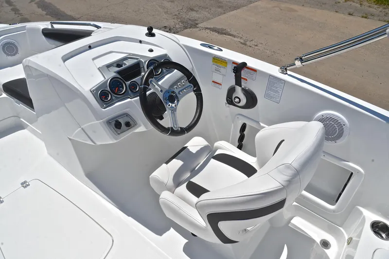 Slide: The Image of Cockpit of 2018 Tahoe 1950 boat with steering wheel and control panel. - 24