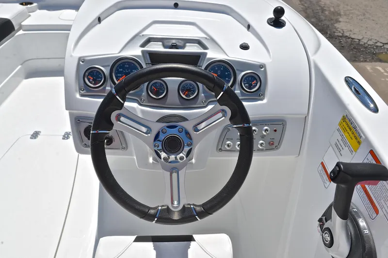 Slide: The Image of Steering console of a 2018 Tahoe 1950 boat with gauges and controls. - 25