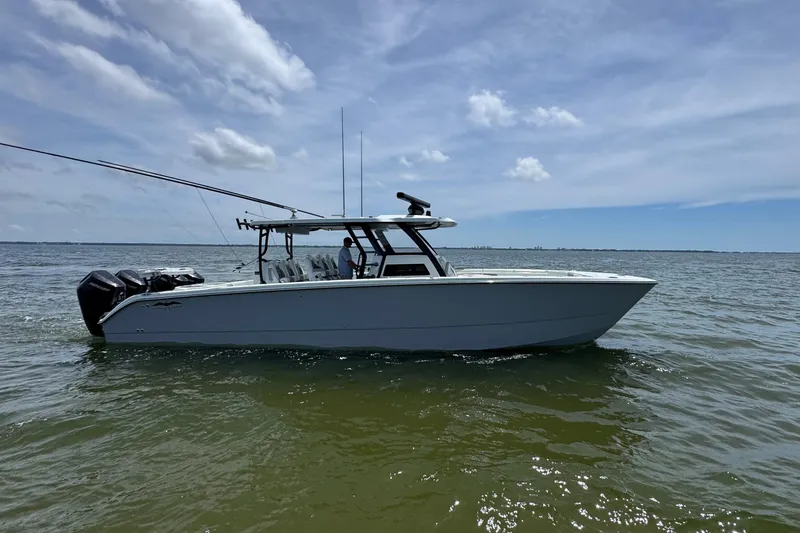 The Image of 2025 Invincible 40 Catamaran on calm waters under a clear blue sky. - 0