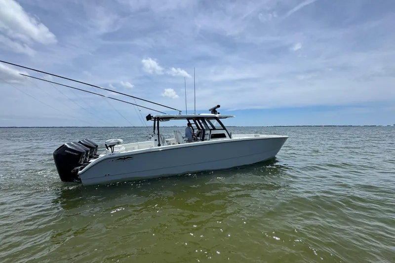 Slide: The Image of 2025 Invincible 40 Catamaran on calm waters under a clear sky. - 1