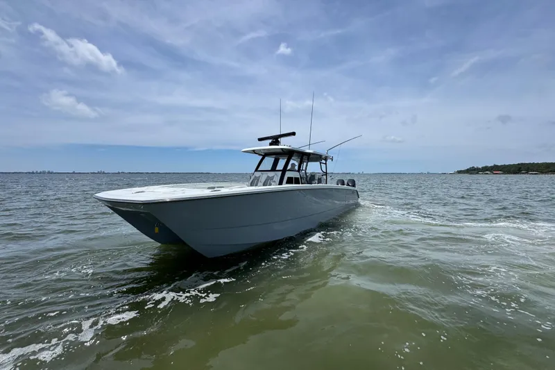 Slide: The Image of 2025 Invincible 40 Catamaran cruising on open water under a clear sky. - 10