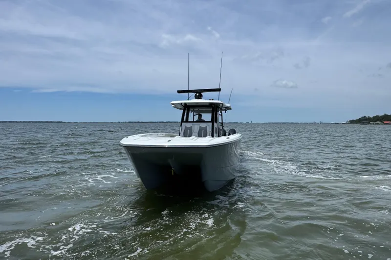 Slide: The Image of 2025 Invincible 40 Catamaran cruising on open water under a clear sky. - 11