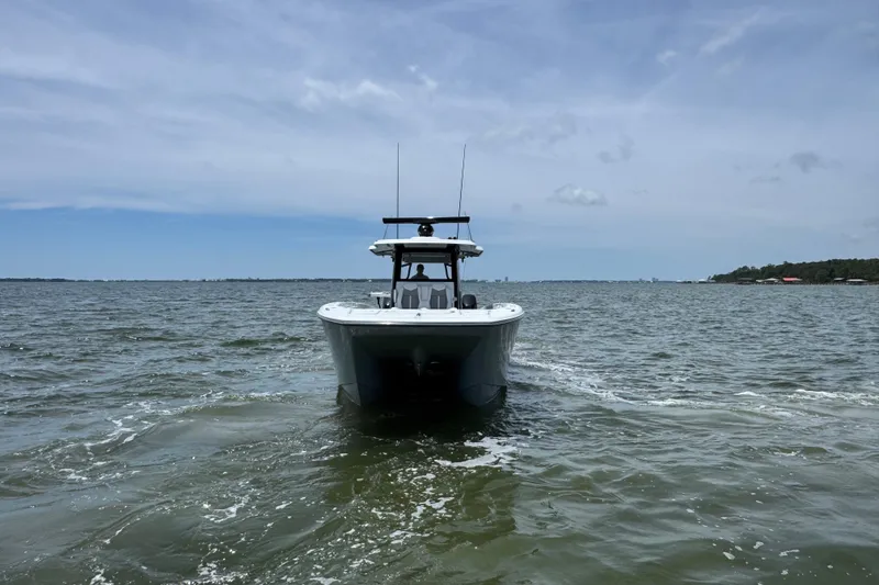 Slide: The Image of 2025 Invincible 40 Catamaran cruising on open water under a clear sky. - 12