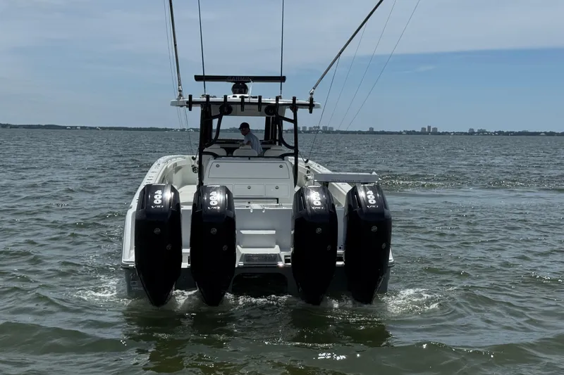 Slide: The Image of 2025 Invincible 40 Catamaran with quad 400 V8 engines on open water. - 13