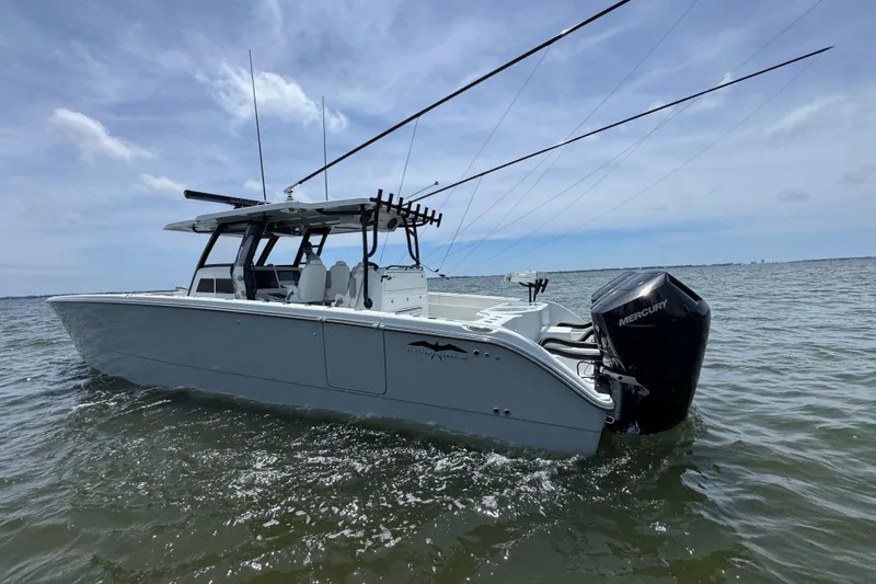 Slide: The Image of 2025 Invincible 40 Catamaran on water, featuring sleek design and powerful Mercury engine. - 16