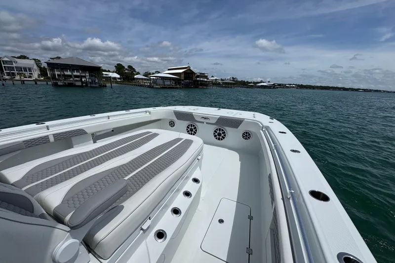 Slide: The Image of 2025 Invincible 40 Catamaran on serene water with luxurious seating and coastal backdrop. - 17