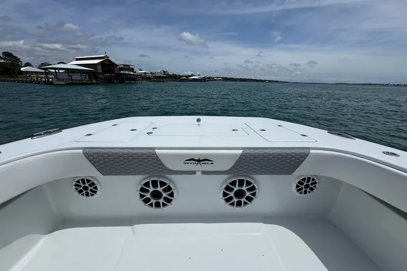 Slide: The Image of 2025 Invincible 40 Catamaran on water, showcasing spacious deck and sleek design. - 18