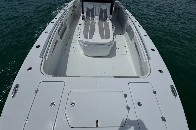 Slide: The Image of 2025 Invincible 40 Catamaran deck with seating, on calm water. - 20