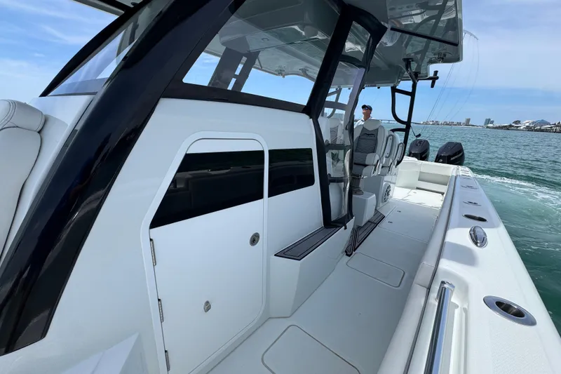 Slide: The Image of 2025 Invincible 40 Catamaran on water, showcasing sleek design and modern features. - 25