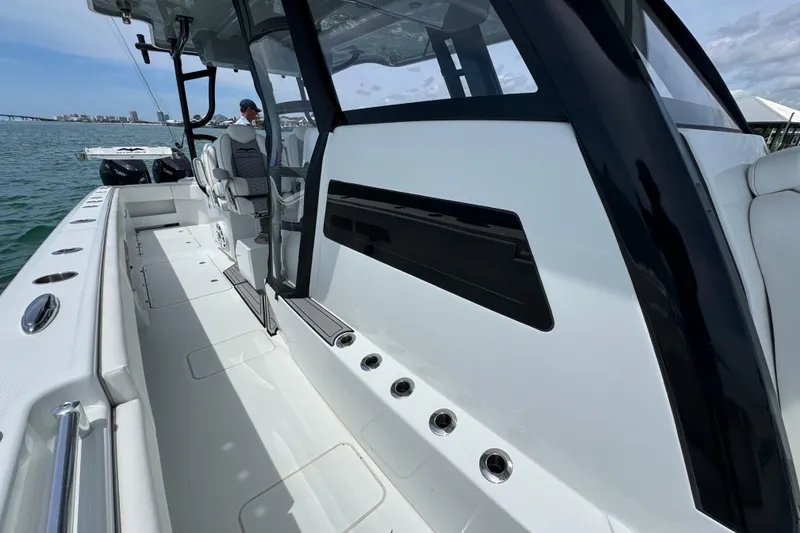 Slide: The Image of 2025 Invincible 40 Catamaran, sleek design, spacious deck, modern features, docked on water. - 26