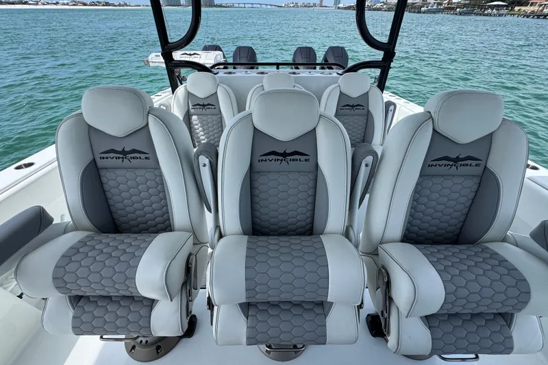 Slide: The Image of Luxury seating on 2025 Invincible 40 Catamaran, featuring sleek design and ocean backdrop. - 28