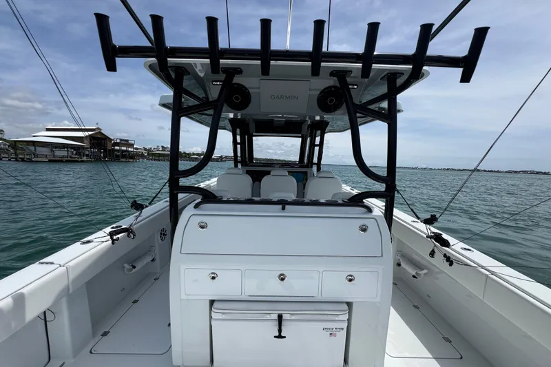 Slide: The Image of 2025 Invincible 40 Catamaran on water, featuring spacious deck and fishing rod holders. - 38