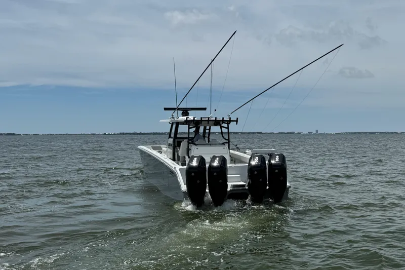Slide: The Image of 2025 Invincible 40 Catamaran with four engines cruising on open water. - 4