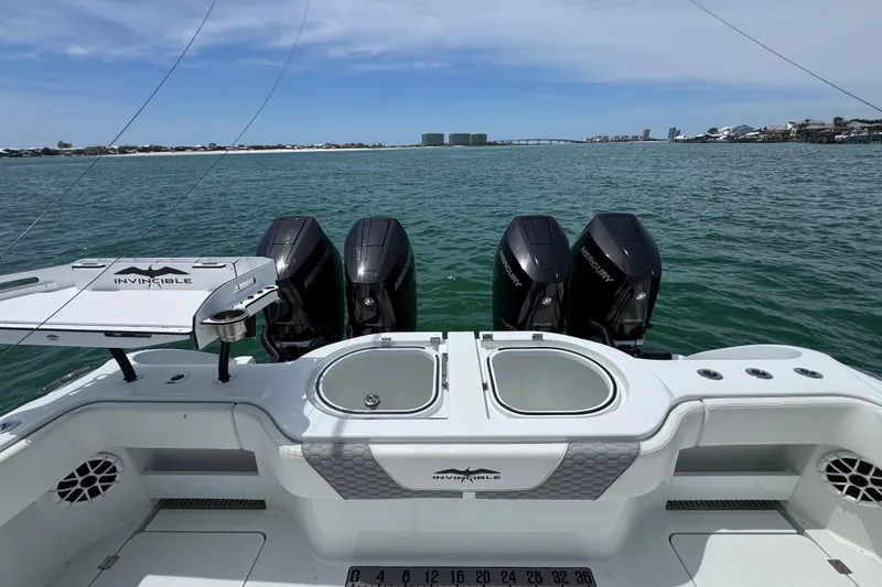 Slide: The Image of 2025 Invincible 40 Catamaran with Mercury engines, featuring a spacious deck and ocean view. - 42