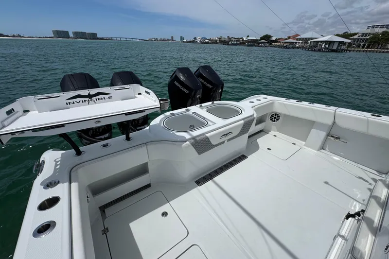 Slide: The Image of 2025 Invincible 40 Catamaran with Mercury engines, docked on calm waters. - 43