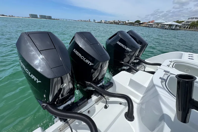 Slide: The Image of Four Mercury outboard engines on a 2025 Invincible 40 Catamaran in open water. - 44