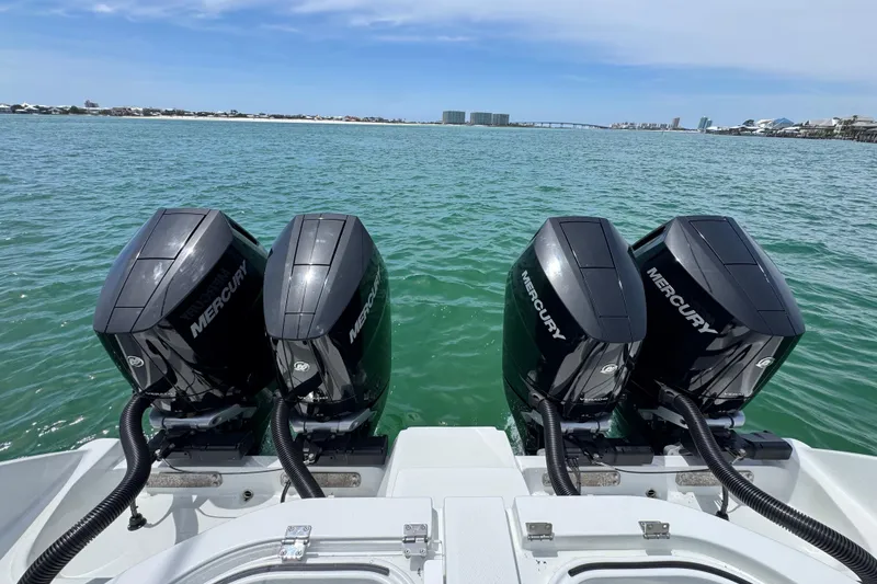 Slide: The Image of 2025 Invincible 40 Catamaran with four Mercury outboard engines on open water. - 45
