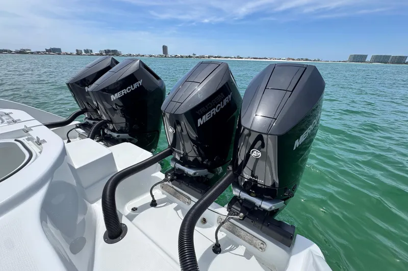 Slide: The Image of Triple Mercury outboard engines on a 2025 Invincible 40 Catamaran in open water. - 46