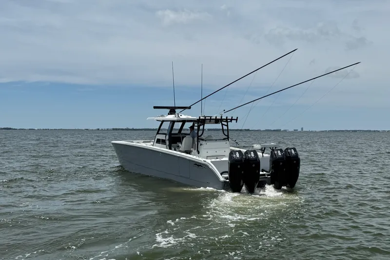 Slide: The Image of 2025 Invincible 40 Catamaran cruising on open water with multiple outboard engines. - 5