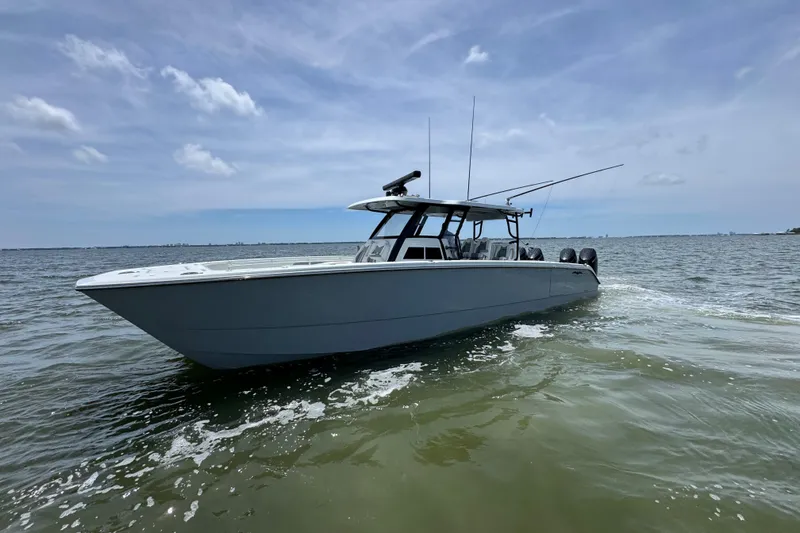 Slide: The Image of 2025 Invincible 40 Catamaran cruising on open water under a clear sky. - 9