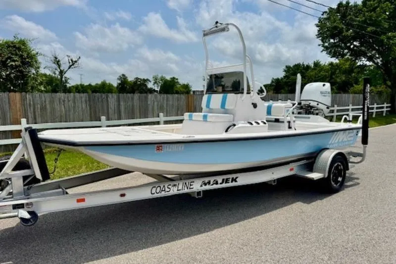 The Image of 2024 Majek 18 M2 boat on trailer, parked on a suburban street. - 1