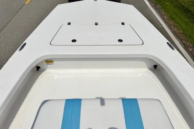Slide: The Image of 2024 Majek 18 M2 boat deck with storage compartment, white and blue design. - 11