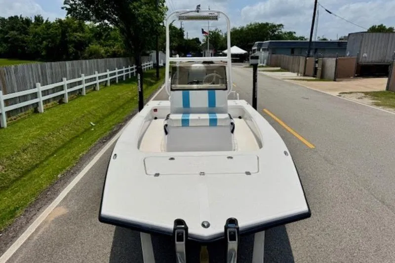Slide: The Image of 2024 Majek 18 M2 boat on a road, showcasing sleek design and spacious deck. - 5