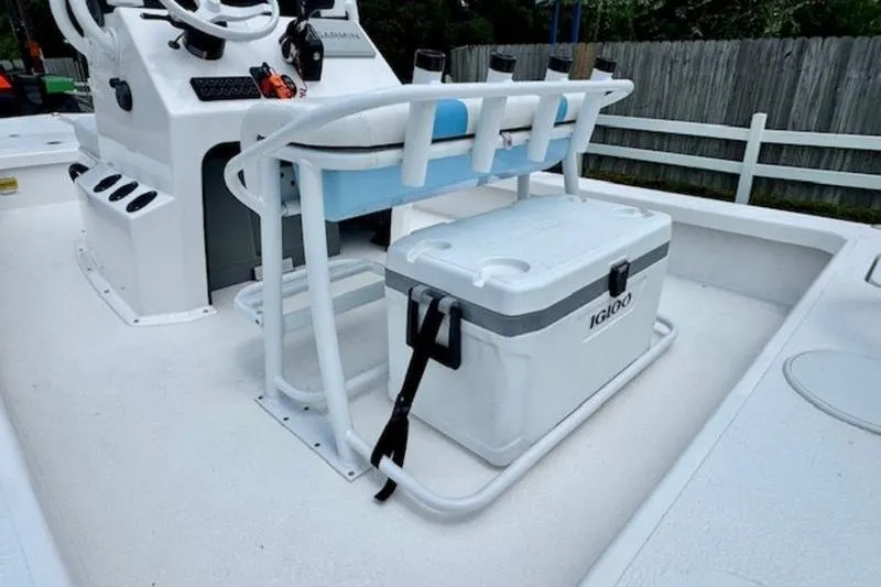 Slide: The Image of 2024 Majek 18 M2 boat interior with console, seating, and Igloo cooler. - 7