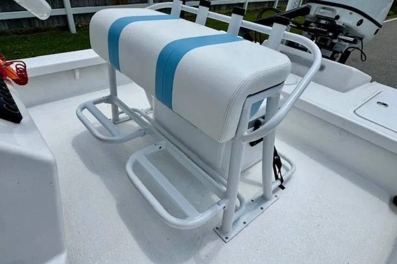 Slide: The Image of 2024 Majek 18 M2 boat with white and blue cushioned seating. - 8