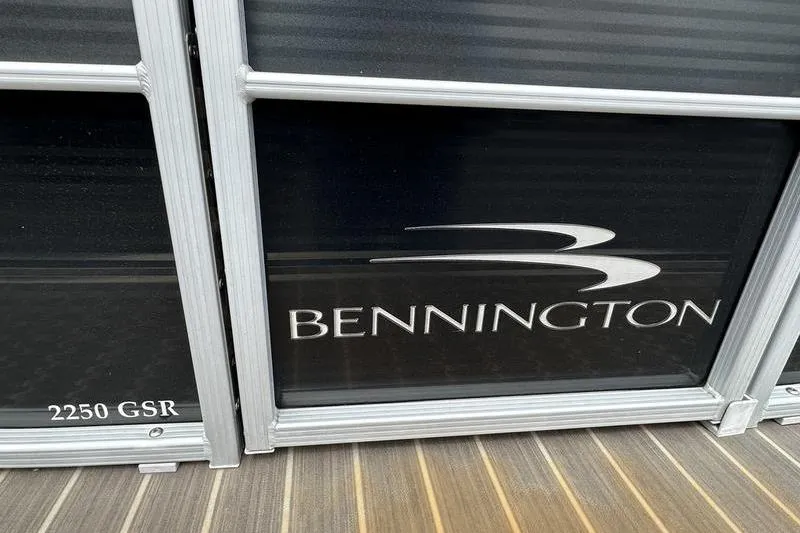 Slide: The Image of 2026 Bennington 2250 GSR boat logo on sleek black panel. - 10