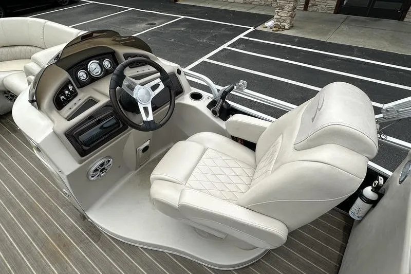 Slide: The Image of Captain's seat and helm of 2026 Bennington 2250 GSR pontoon boat, featuring modern controls. - 18
